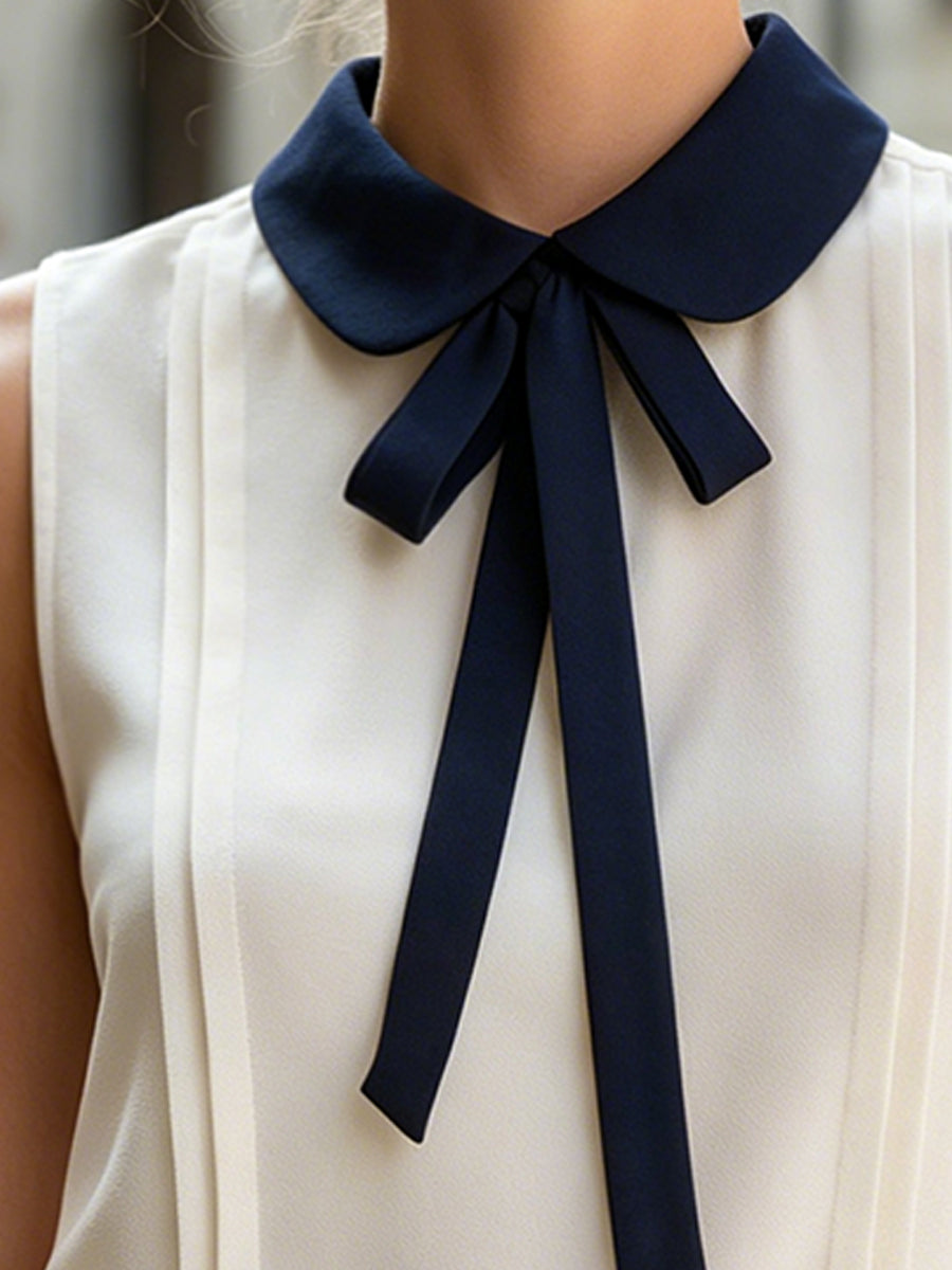 Sleeveless Blouse With Navy Peter Pan Collar And Bow Tie